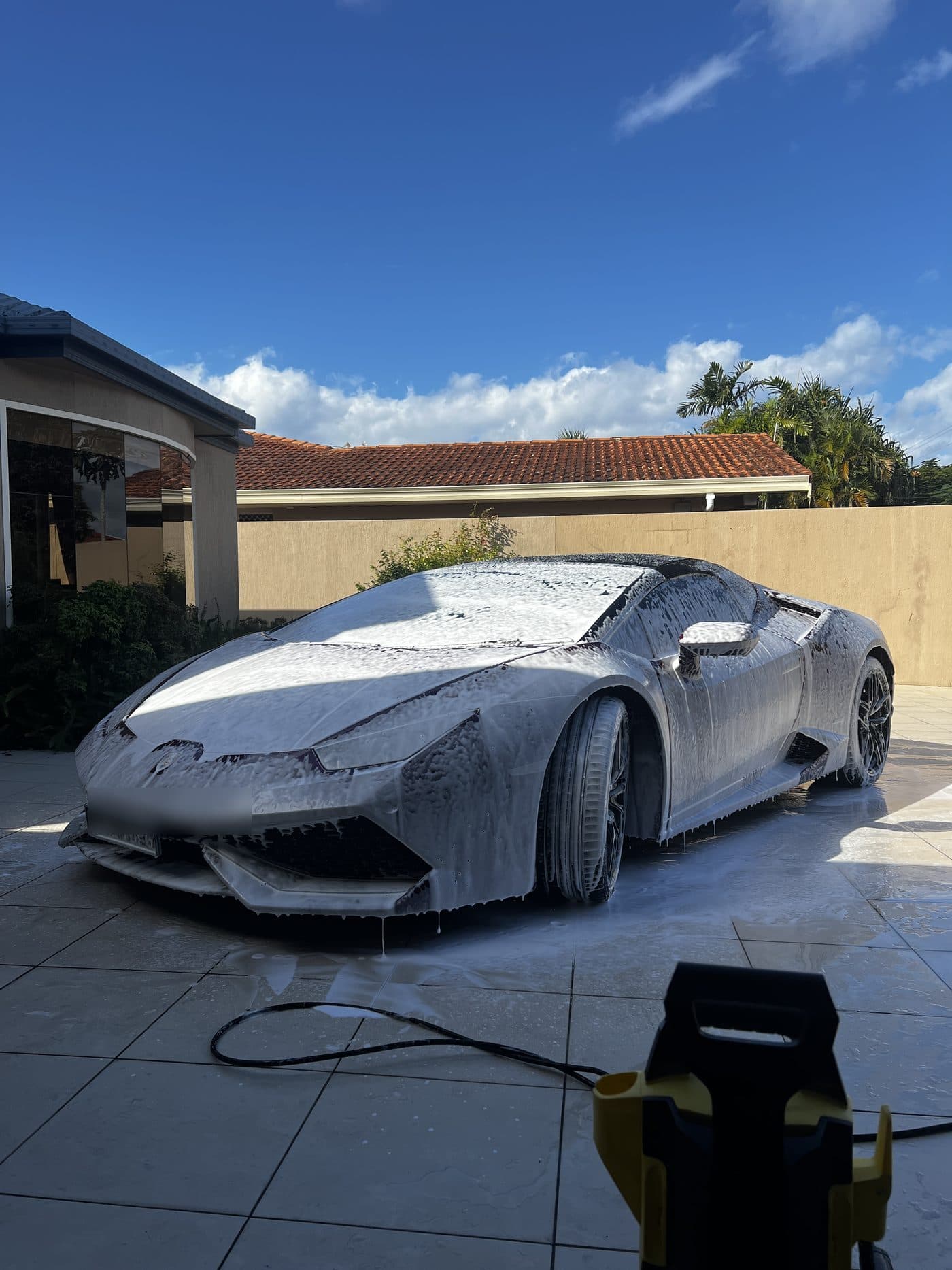 Lamborghini Huracan covered in snow foam during a wash