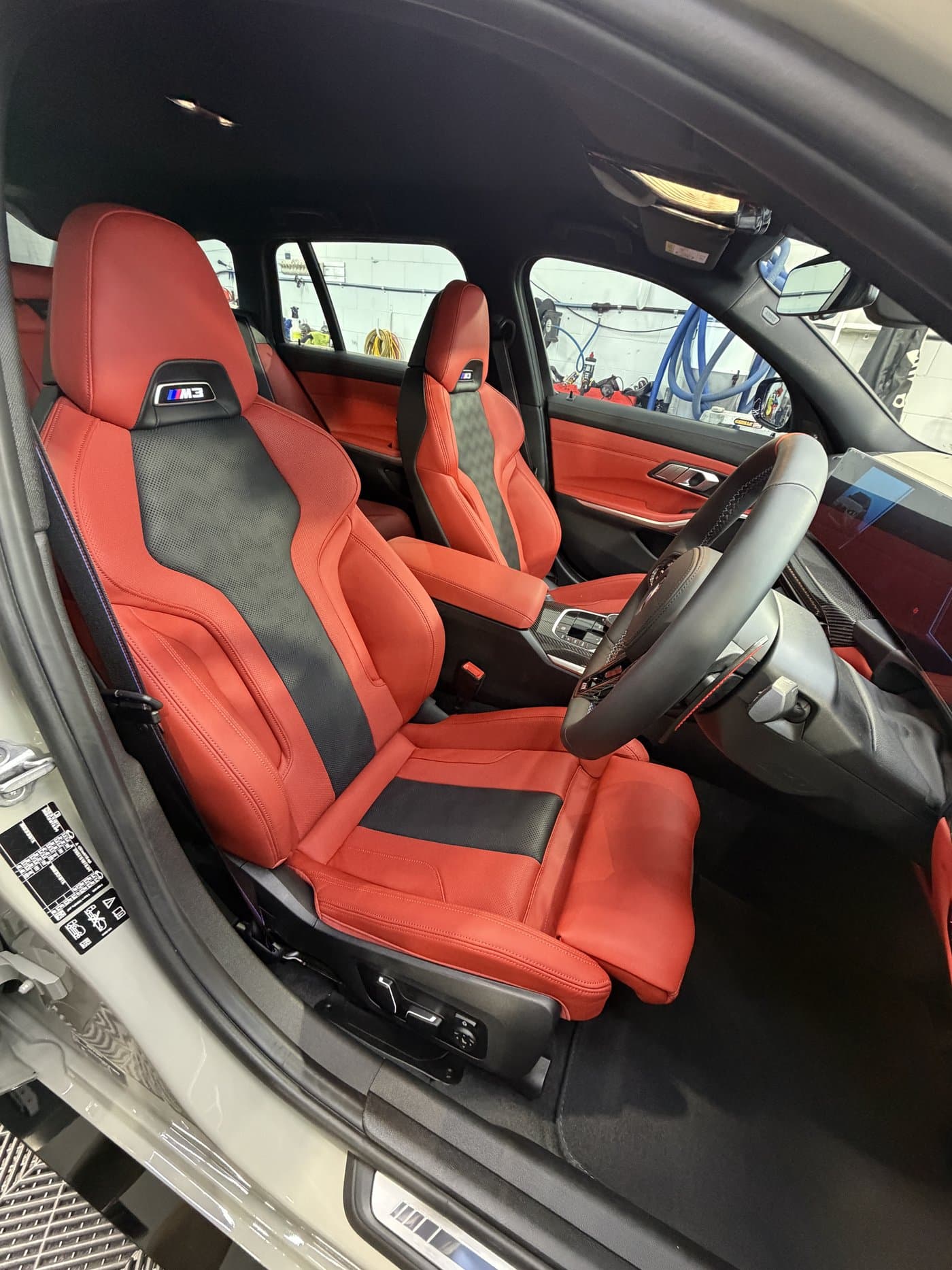 BMW M3 red and black M-Sport interior detail