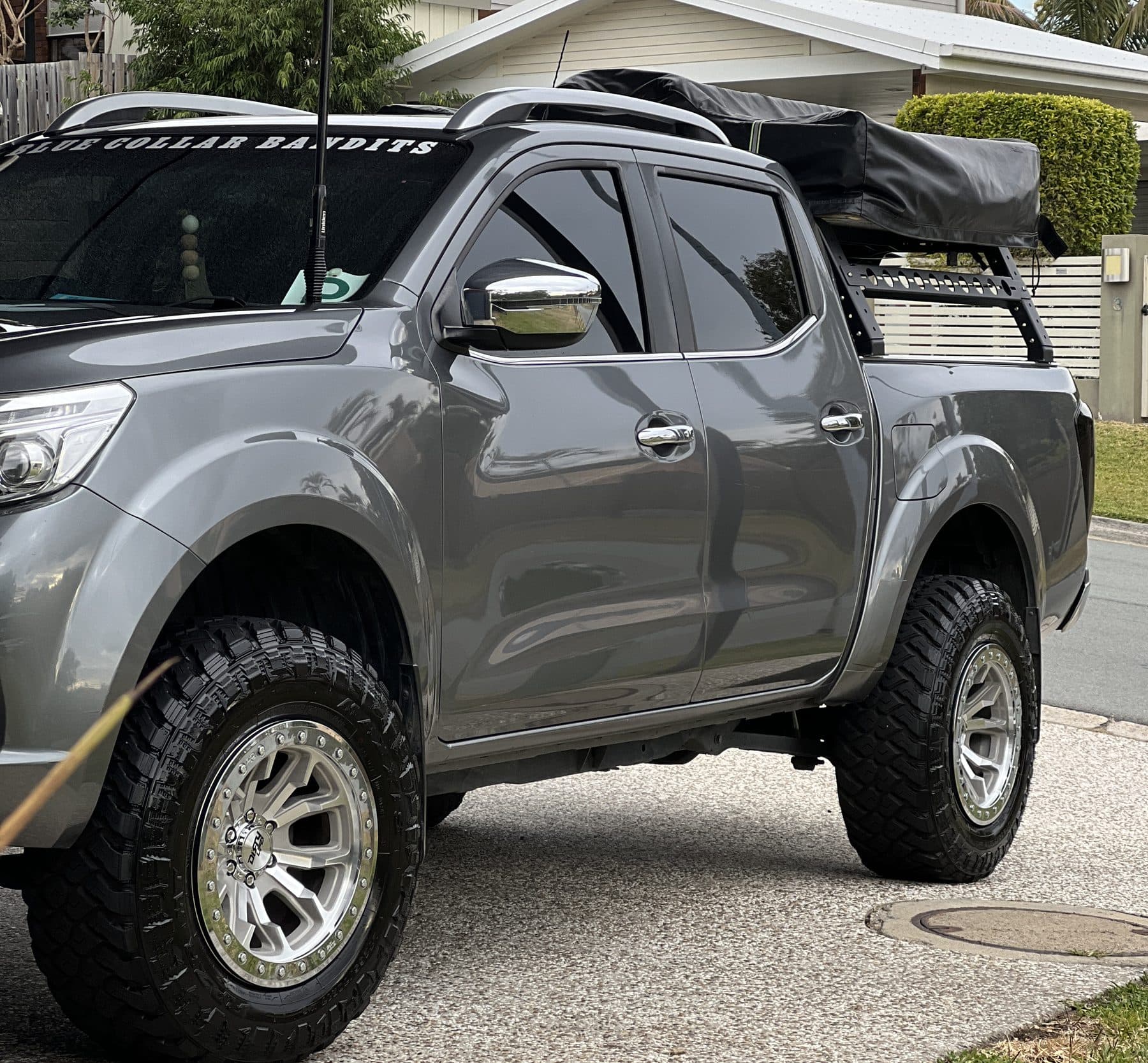 Grey 4x4 ute fitted with a canopy, roof rack and off-road wheels